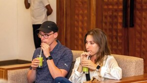 Two people sitting on a sofa with drinks, in a room with wooden paneling. - BPR Asgiriya (Kandy)