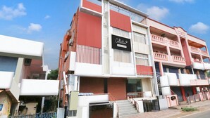 A multi-story building with a prominent sign reading 'Collection & Company Services.' - Super Hotel O MVP Double Road (Visakhapatnam)
