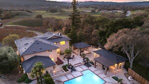 A residential property with a swimming pool, patio area, and multiple outdoor seating arrangements. - Sleeps 18, 2 Homes | Vineyard Estate + Pool + Hot Tub | Minutes to Templeton (Templeton)