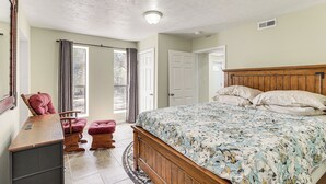 A bedroom with a wooden bed, a desk, a chair, and a window with curtains. - Near Bruce's Field, Downtown & Hospital! Cozy Unit (Aiken)