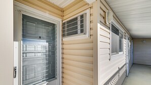 A corridor with sliding glass doors and windows, a ceiling vent, and a white exterior wall. - 2 Blocks to Beach & Boardwalk: Ocean City Condo (Ocean City)