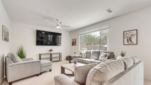 A living room with a sofa, coffee table, and TV. - 4 Mi to Empire Polo Club: Getaway w/ Outdoor Oasis (Coachella)