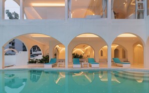 A pool area with lounge chairs and arched ceilings. - Yangshuo Minos Hotel (Guilin)