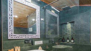 A bathroom with a wooden ceiling, a white vanity, a large mirror, and a shower area. - Konifer Villas By ELIVAAS (Kasauli)
