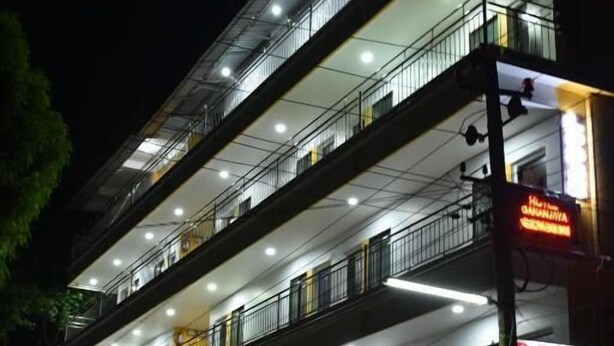 A multi-story hotel with balconies, a restaurant, and a sign for 'Hotel Gananjaya.' - Hotel Gananjaya Gokarna (Gokarna)