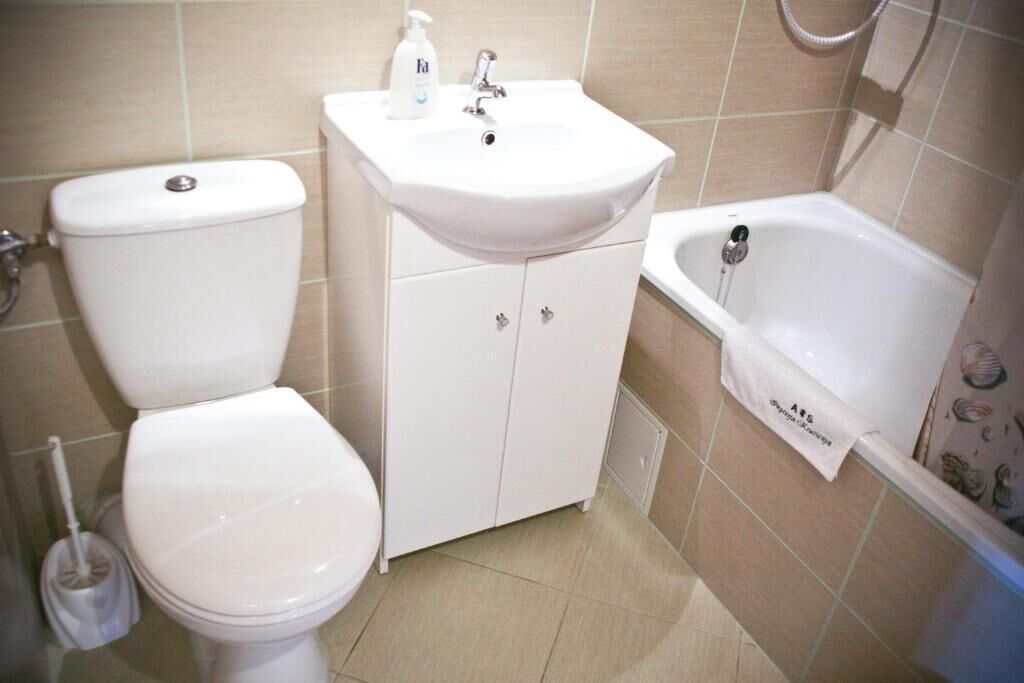 A bathroom with a toilet, a sink, and a bathtub.