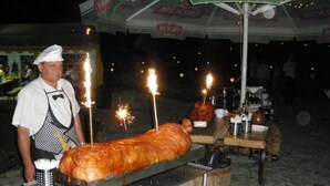 A large roasted pig with sparklers on a street food stall. - Impresja Krasiczyn (Krasiczyn)