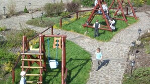 A playground with swings and climbing structures. - Impresja Krasiczyn (Krasiczyn)