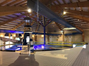 An indoor swimming pool with a high ceiling, wooden beams, and a central water feature. - Renovated house in Breskens near Cadzand Zeeuws-Vlaanderen by the sea Zeeland. (Breskens)
