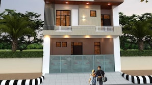 A modern two-story building with balconies, large windows, and a gated entrance. - Hotel Deep (Shri Madhopur)