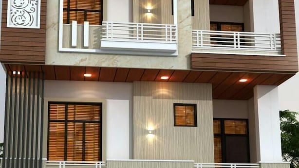 A modern two-story building with balconies, large windows, and decorative elements. - Hotel Deep (Shri Madhopur)