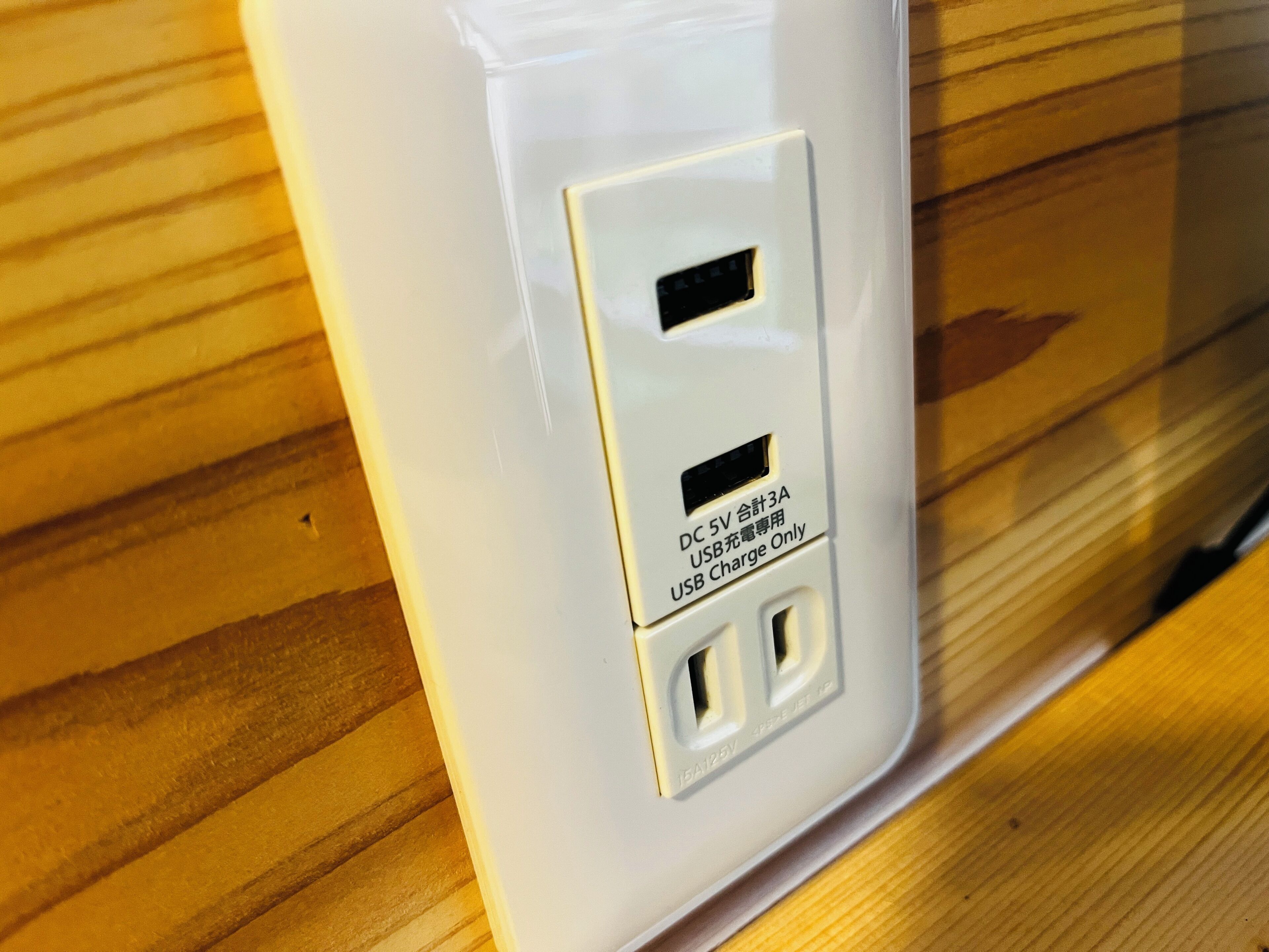 A white electrical outlet with a USB port and a label indicating it is for USB charging only.