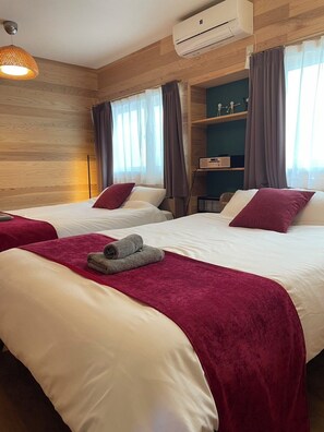 A hotel room with two beds, a ceiling fan, an air conditioning unit, and a shelf with decorative items. - Family groups all together! Sea, mountains, power spots/table tennis, games, relaxation (Turuokashi)