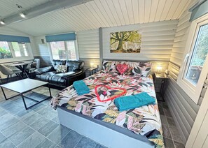 A bedroom with a bed, a sofa, a desk, and a window. - 0 bedroom accommodation in Brecon Beacons National Park, (Brecon Beacons National Park,)