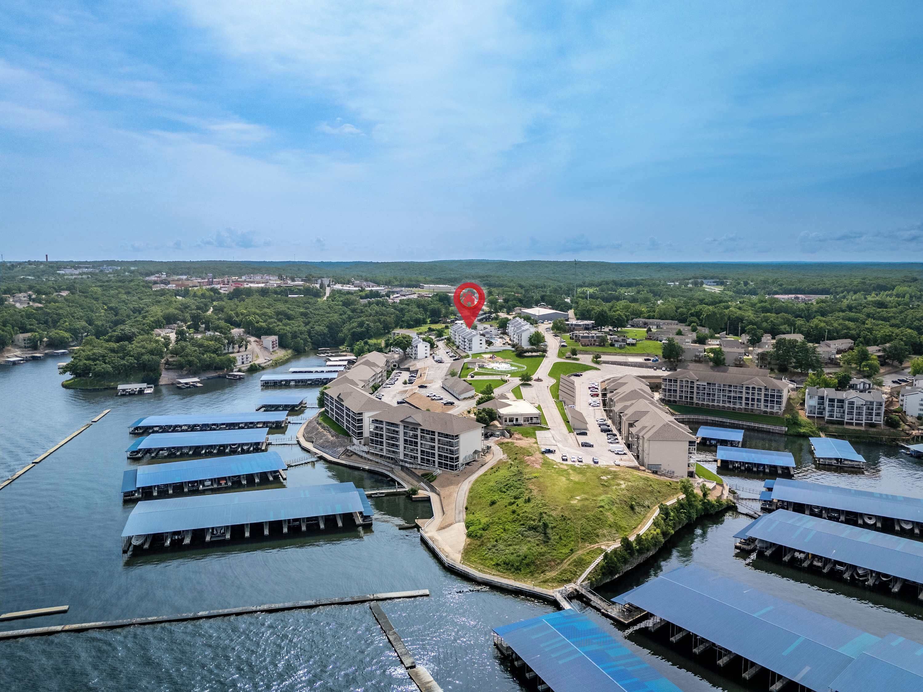 A waterfront hotel with multiple buildings, a dock, and a river.