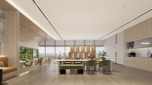 A modern interior with a dining area, seating, and a kitchen.