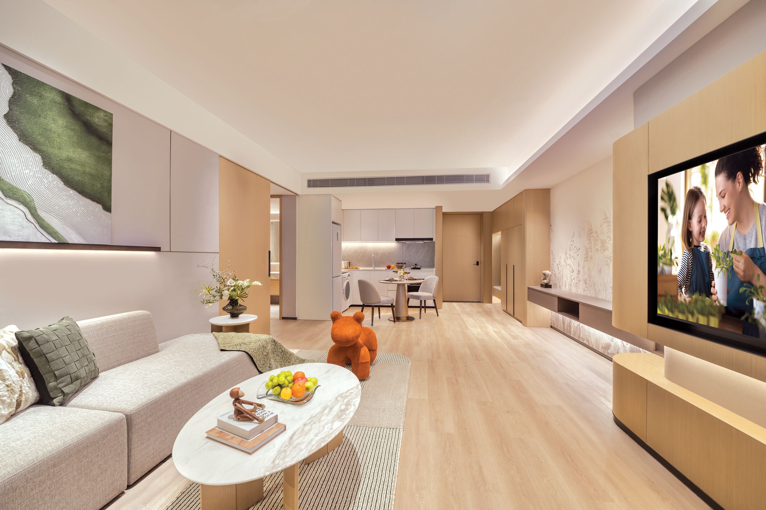 A modern living room with a sofa, coffee table, and a TV.