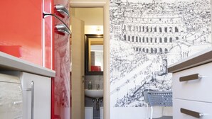 A modern bathroom with a red and white color scheme, a sink, and a mirror. - Baronio@home - One Bedroom Apartment, Sleeps 4 (Rome)