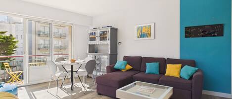A modern living room with a sofa, armchair, and coffee table.