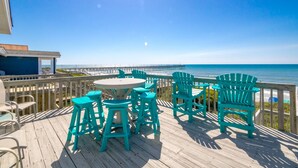 A wooden deck with outdoor seating and a view of the ocean. - What A View: Oceanfront 6-bedroom home in Surf City perfect for families. (Surf City)