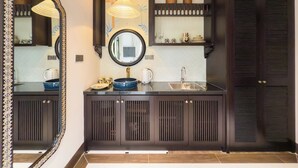 A modern bathroom with a large mirror, a sink, and a vanity with cabinets. - Natalie Indochine Mountain Villa Da Nang (Da Nang)