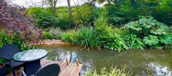 Tranquil cottage stay with fireplace and pond