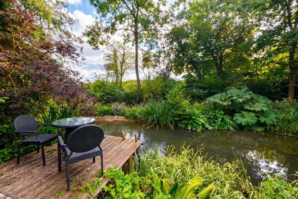 Dine or unwind on the private deck surrounded by the lush garden pond.