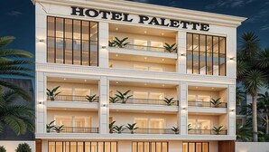 A multi-story hotel with balconies, large windows, and a sign reading 'HOTEL PALETTE.' - Palette Convention Hotel Millennium (Gurugram)