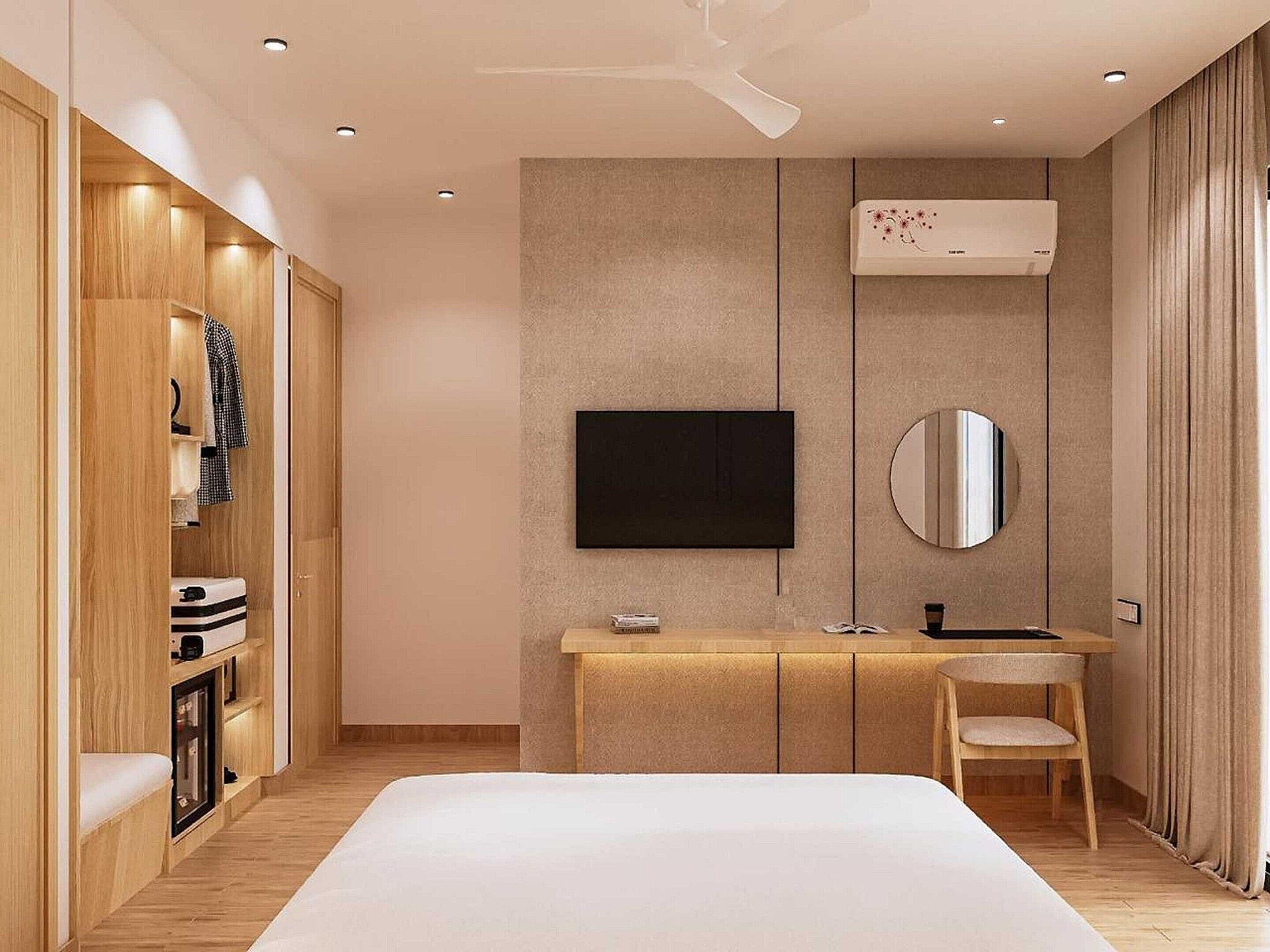 Une chambre à coucher moderne comprenant un lit, une télévision, un miroir, une coiffeuse et une armoire.