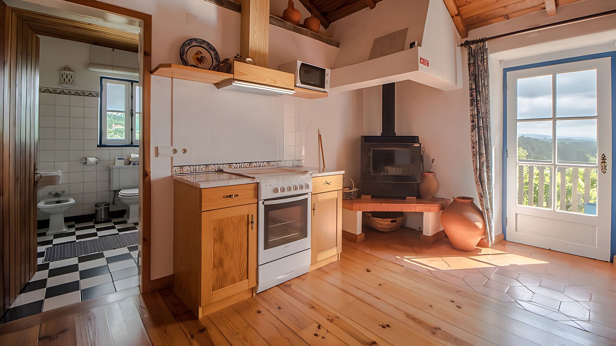 Una cocina con armarios de madera, estufa y microondas.