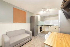 Desk, laptop workspace, blackout drapes, iron/ironing board
