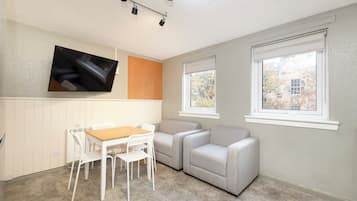 Desk, laptop workspace, blackout curtains, iron/ironing board