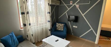 Quadruple Room, Balcony | Living area