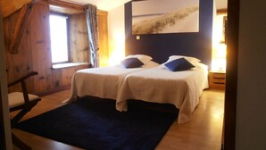 A room with two beds, a wooden ceiling, a large window, and a painting on the wall. - Guest Room 'Chambre Rivage' with Shared Terrace & Garden, Wi-Fi (Polignac)