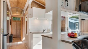 A modern kitchen with white cabinets, a countertop, and a fruit bowl. - Lovely holiday home with annex and wilderness bath. (Vestervig)