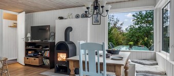 Cozy holiday home with terrace and wood-burning stove close to the water.