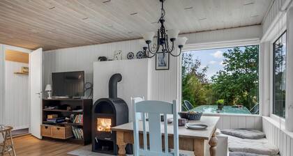 Cozy holiday home with terrace and wood-burning stove close to the water.