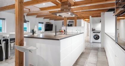 16-person holiday home with view over the water and wilderness bath.