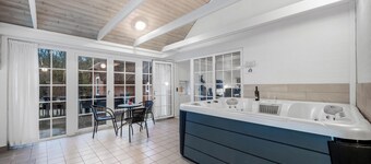 Lovely pool house with jumping cushion and activity room.