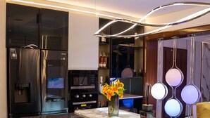 Une cuisine moderne équipée d’un réfrigérateur, d’un four à micro-ondes et d’une cuisinière intégrés.