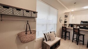 A kitchen with a bench, a hanging basket, and a window with blinds. - Beach Access & Poolside Patio! Easter Special! (South Padre Island)