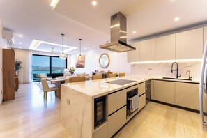 A modern kitchen with a built-in oven, a sink, and a dining area with a view. - Stunning 2nd-Level | Views of Ocean, Beach & Pool (Huatulco)