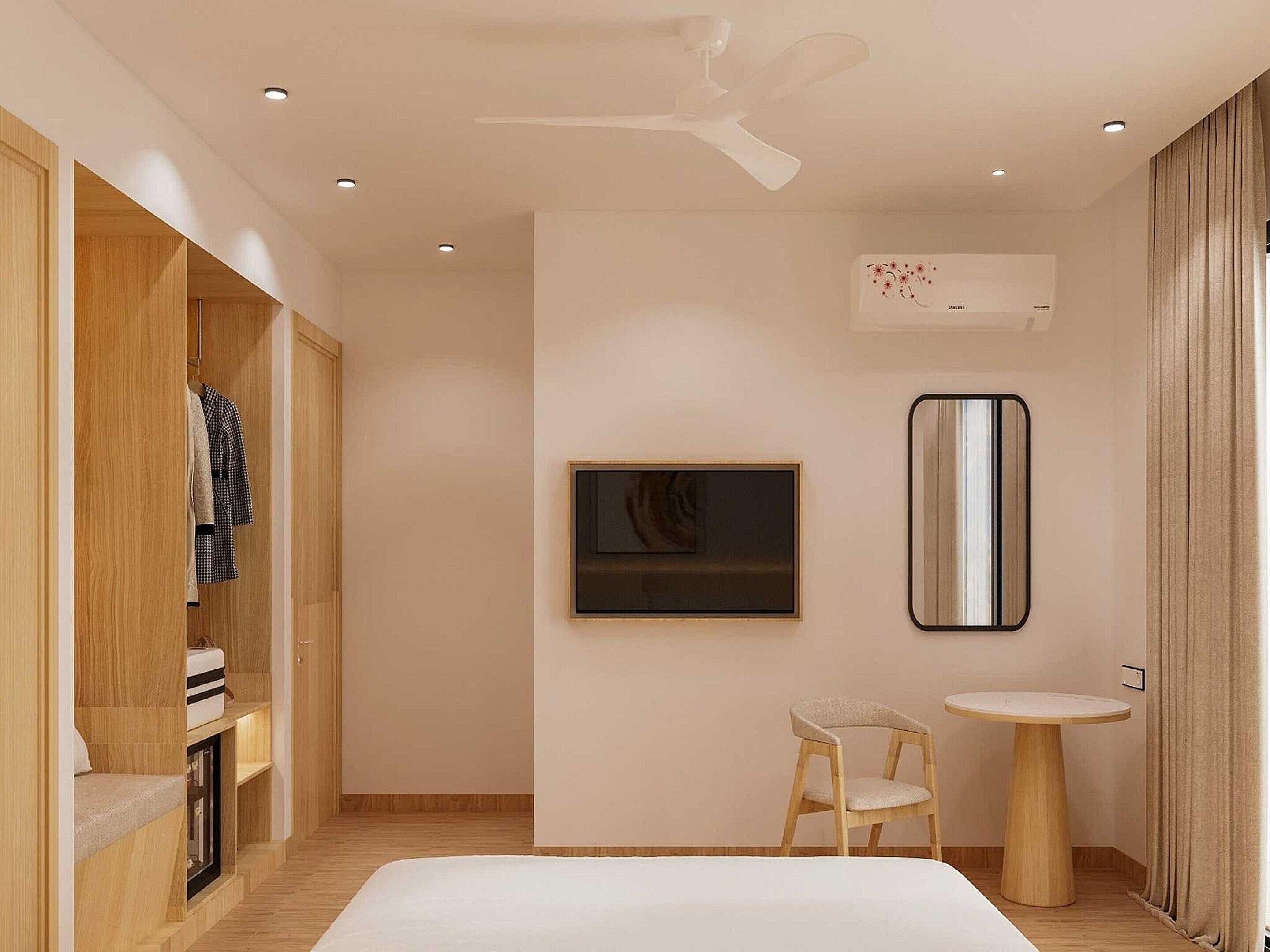 A modern bedroom with a bed, a small chair, a round table, a ceiling fan, and a wall-mounted air conditioning unit.
