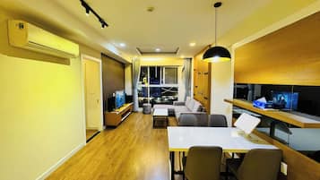 Family Apartment, 2 Bedrooms, City View | Living area | 55-inch Smart TV with satellite channels