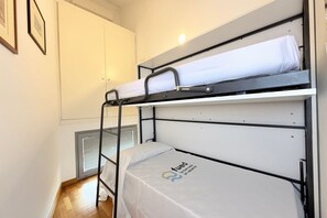 A bunk bed room with a ladder, a radiator, and a framed picture on the wall. - SE231 – Senigallia, renovated apartment with a/c (Senigallia)