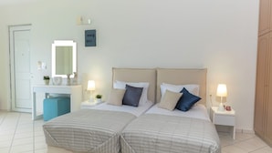 A double bed with two nightstands, a bedside table, a desk with a chair, a mirror, and a wardrobe. - Cretan Experiences Sea View (Malevizi)