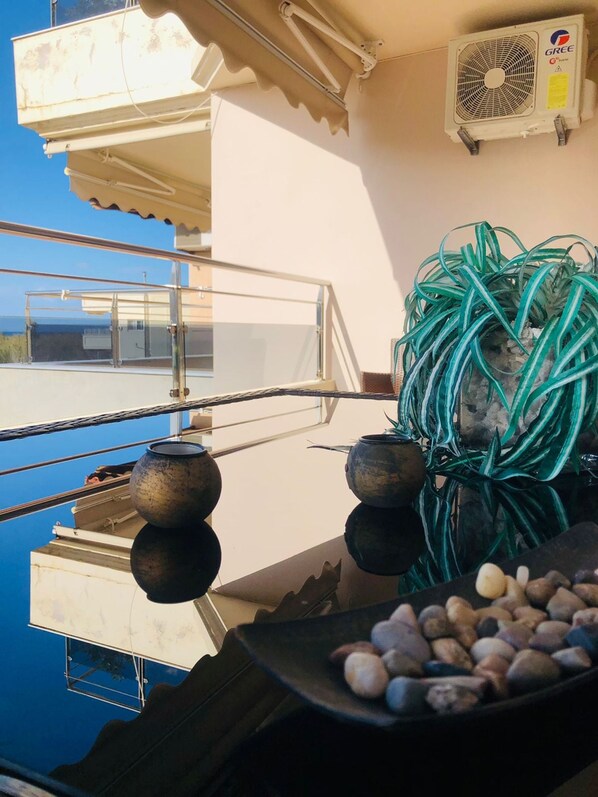 A balcony with a view, a fan, and a plant. - Ariadni s Apartment 1 in Chania City (Chania)
