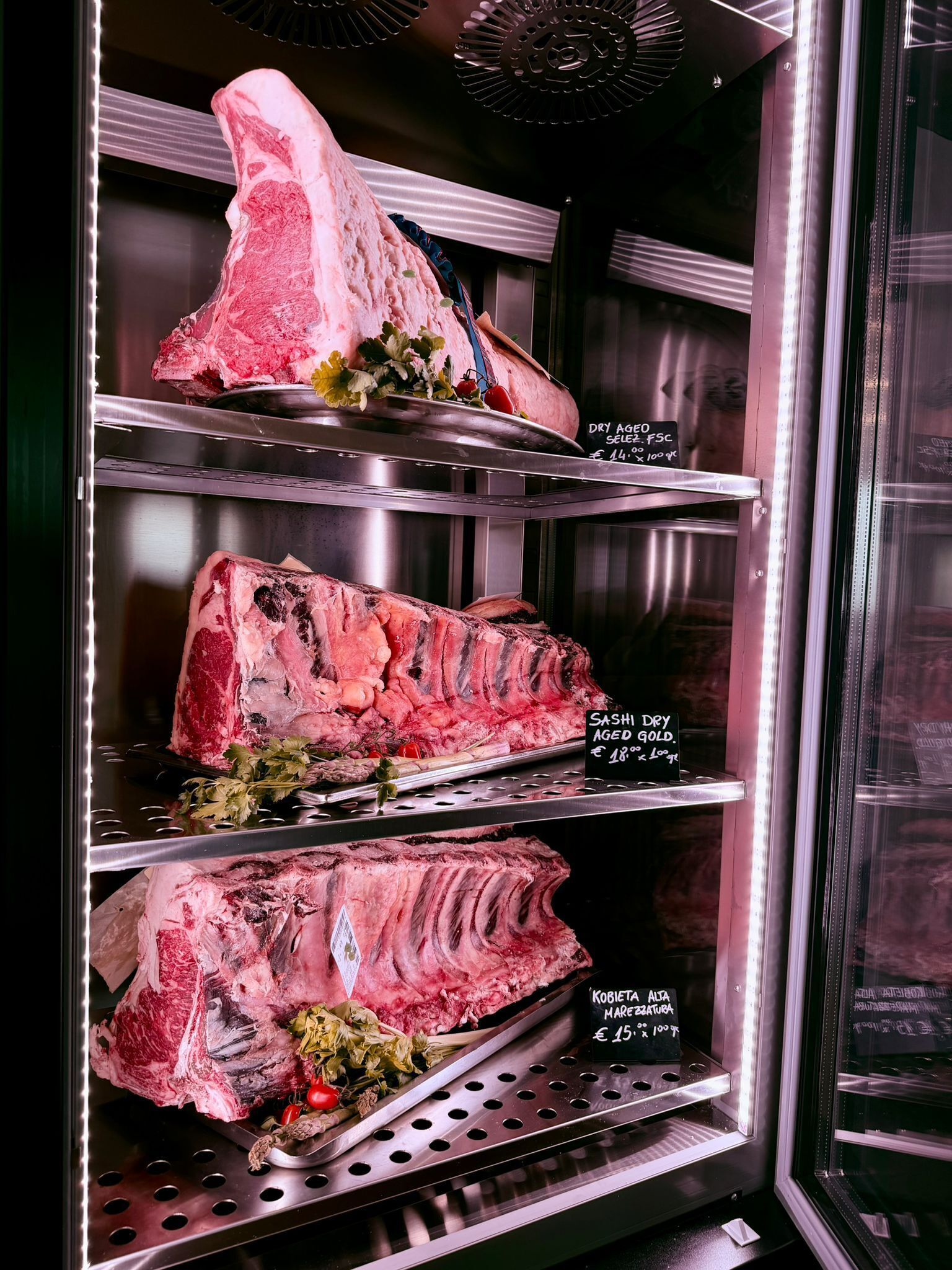 A meat display with labels indicating different cuts and prices.