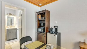 A compact kitchen with a microwave, coffee maker, and a cabinet with a coffee grinder. - 1 Mi to Midtown & Stadium! Couple's Haven in Tampa (Tampa)
