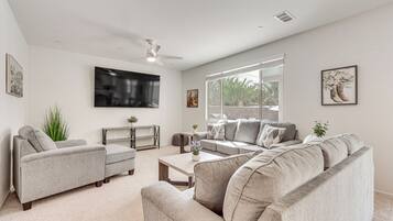 A living room with a sofa, coffee table, and TV.